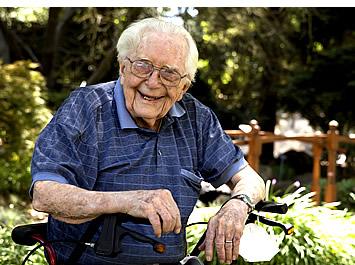 Glen sitting in the garden smiling