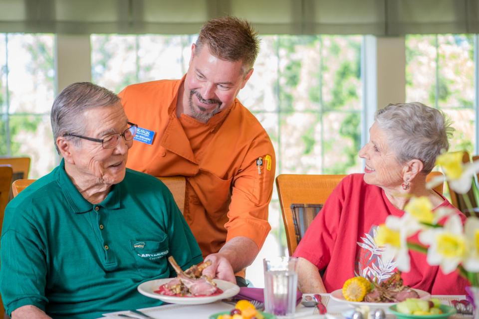 Couple being served in the dining room.