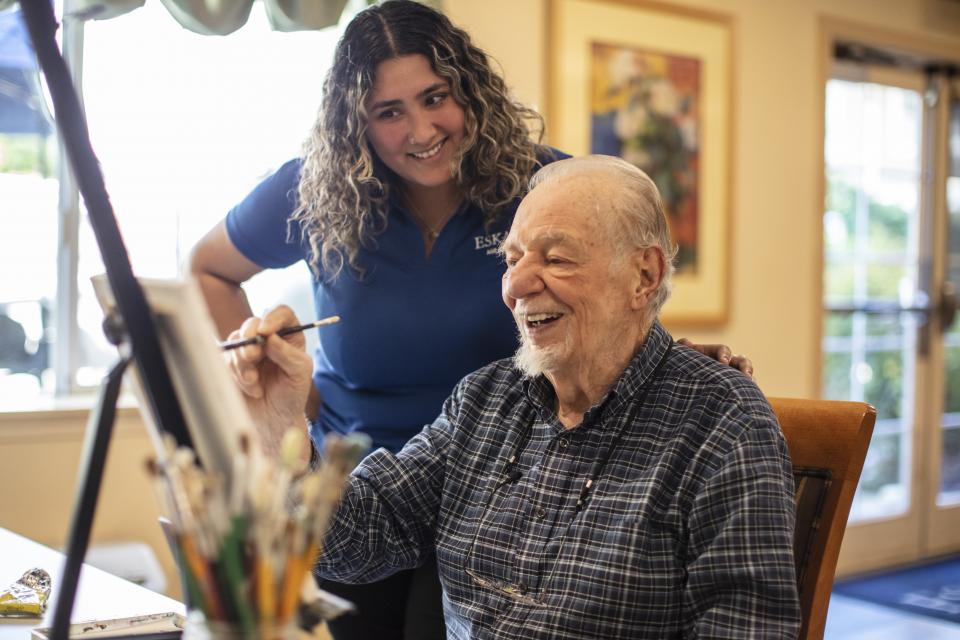 Resident and staff talking a walk together