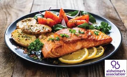 Dinner plate of salmon, potatoes and salad greens