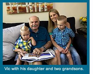 Resident Vic sitting on the couch with his daughter and two grandsons.