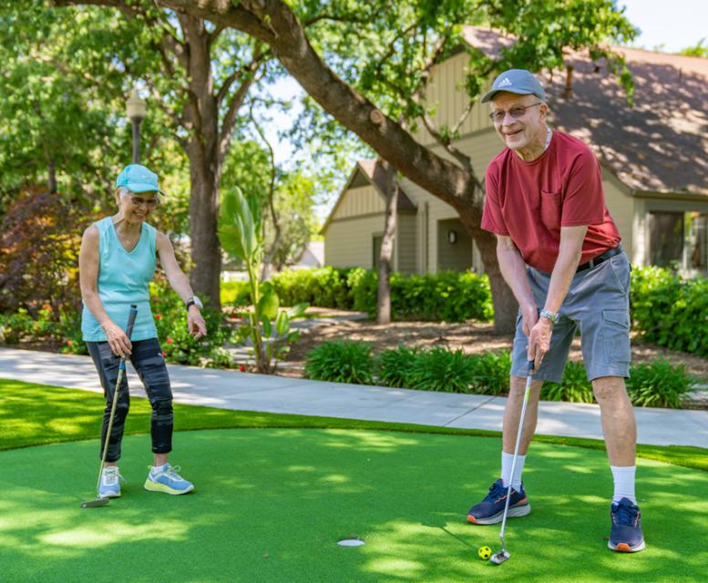 Couple practicing on the putting green