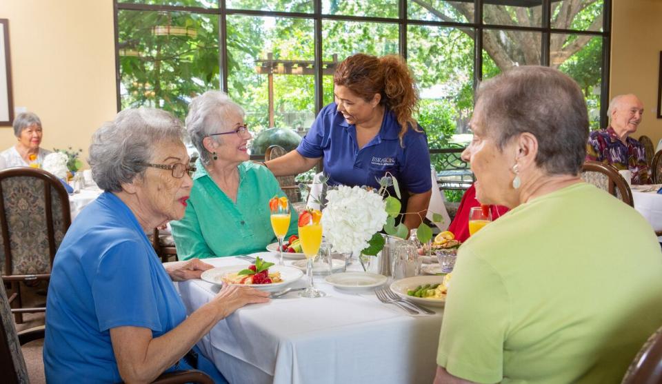 three female resident enjoying a meal in the dining room