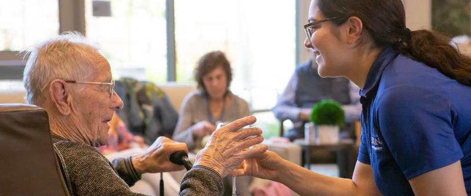 Staff serving resident a glass of wine